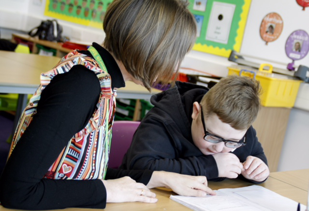 Teacher helping student