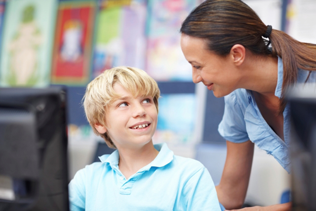 Teacher and student in IT classroom