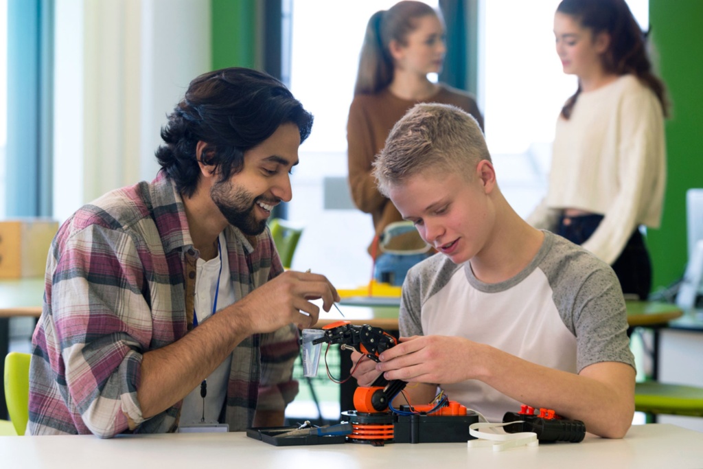 Teacher helping student with building