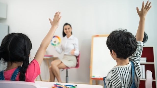 Pupils-raising-hands-in-a-classroom