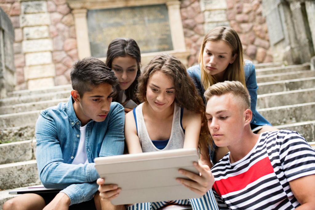 High school students gathered around a tablet