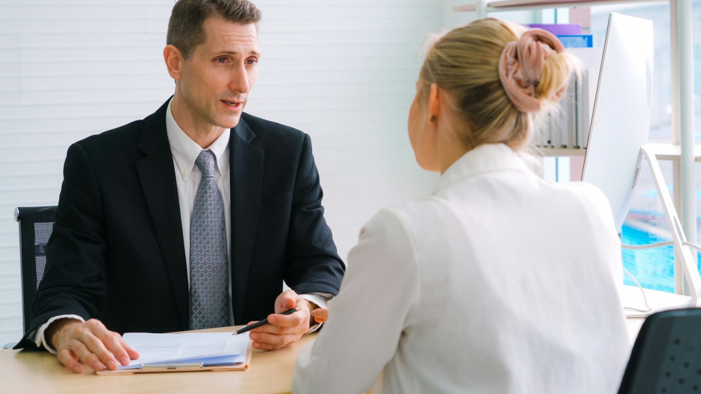 External investigator speaking with teacher in an interview room