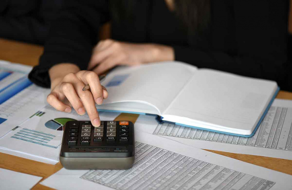 Female student using calculator for a Functional Skills Qualification.