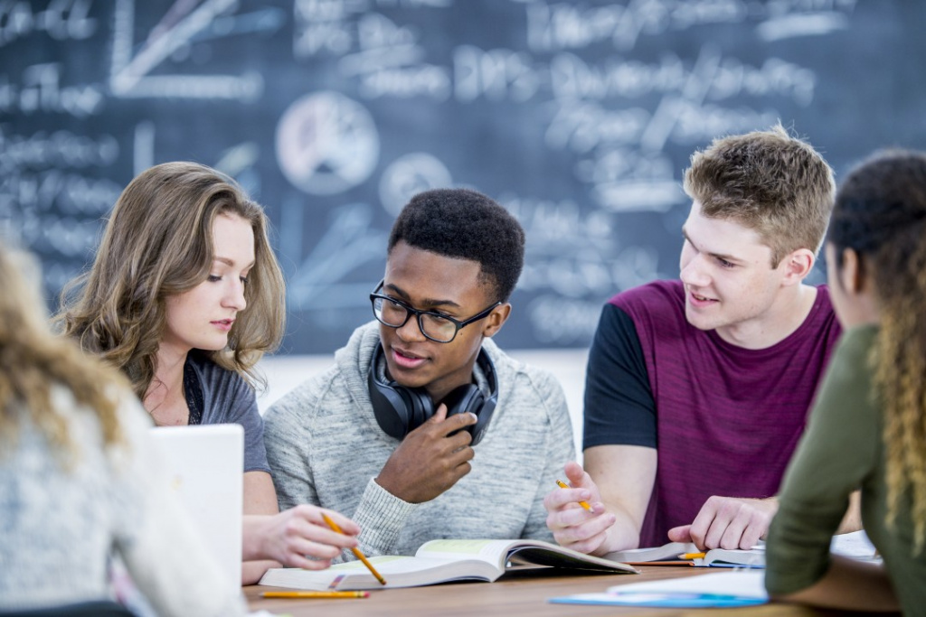 A-level chemistry students studying at a classroom table.