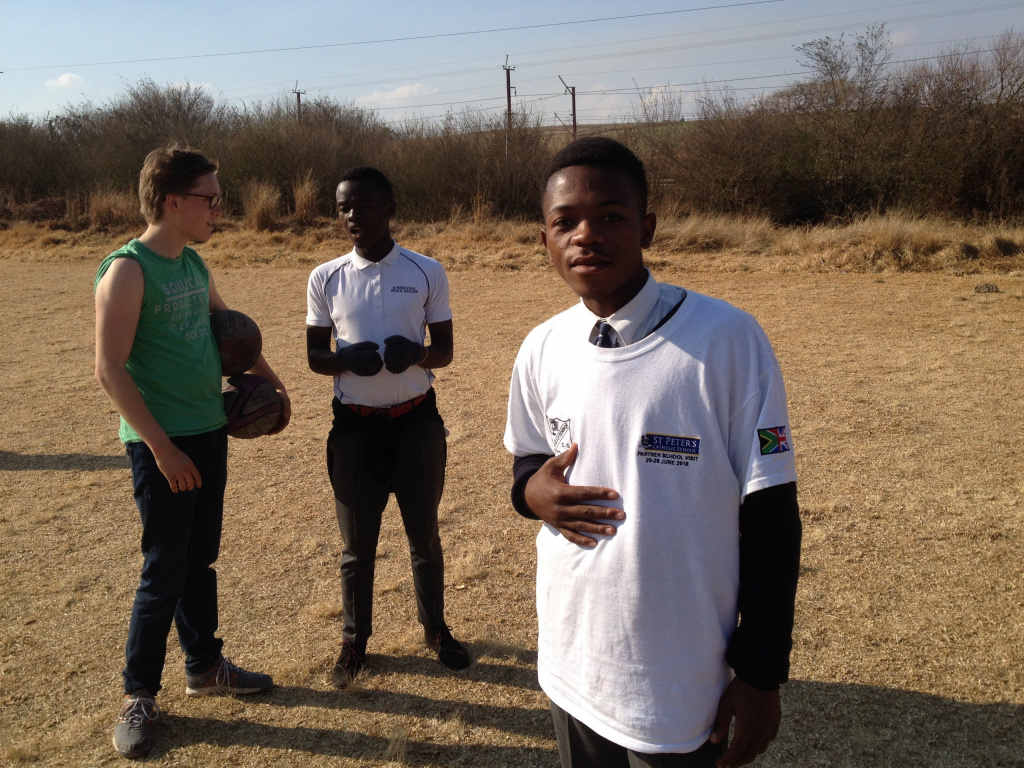 South African secondary school boys standing outside.