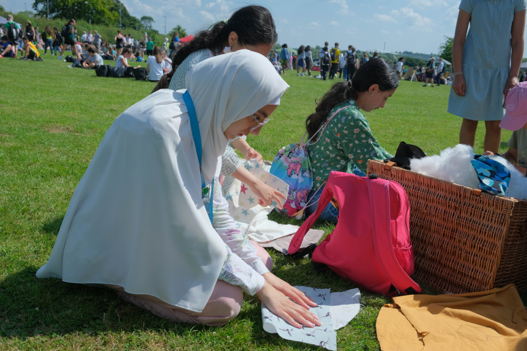 Teenage Muslim girl making signs at an environmental rally to protest climate change.