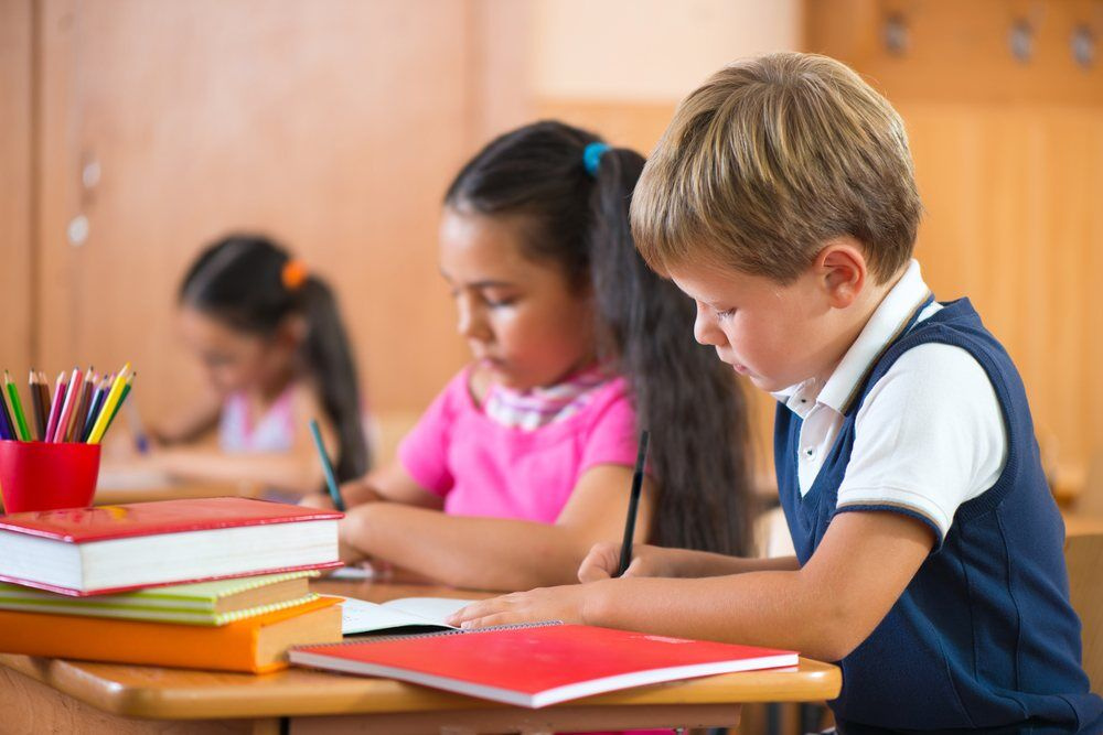 Primary school pupils sitting a SATs exam paper.