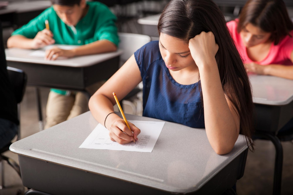 Secondary or high school students taking an exam in a hall.