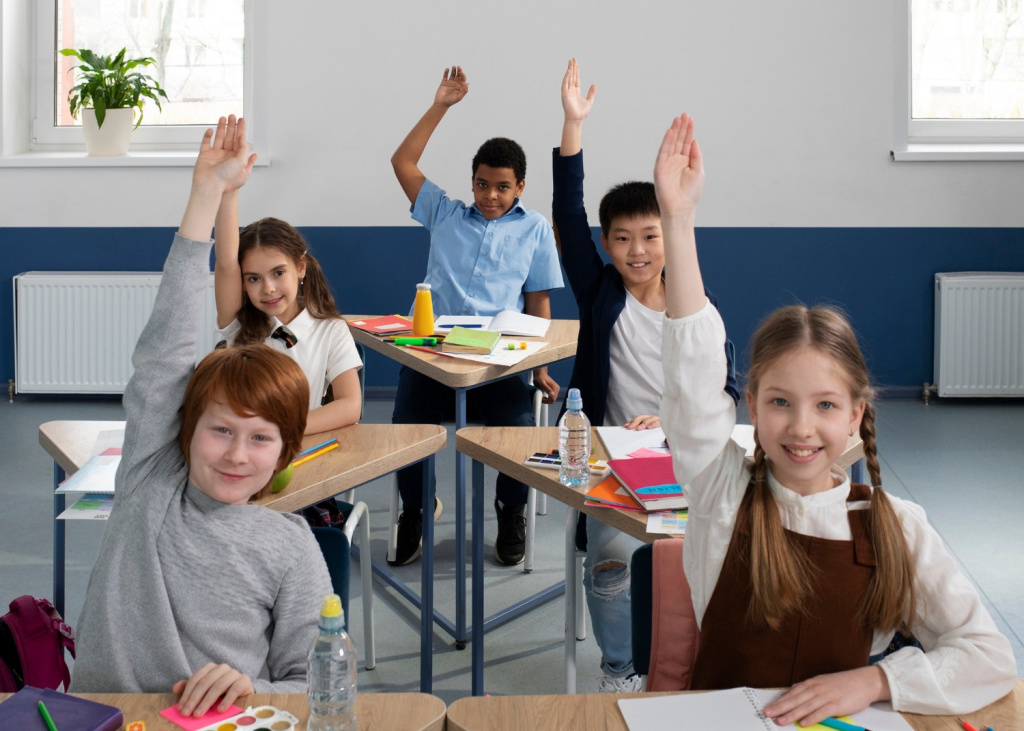 Class of American middle school students raising their hands in a lesson.