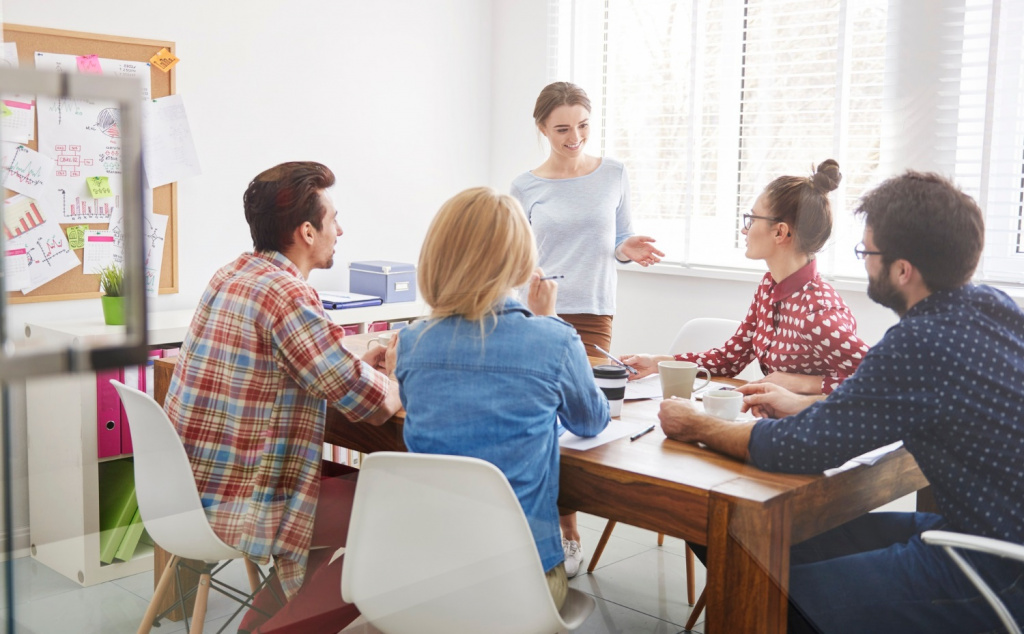 Teachers collaborating in a staff room meeting.