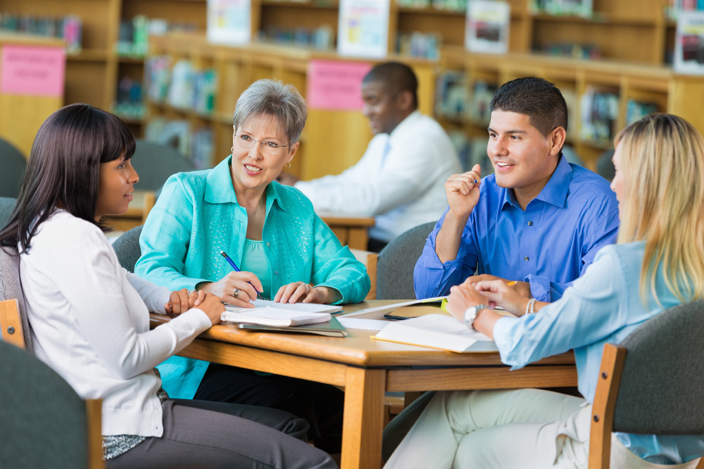 School leadership team having a meeting in a library.