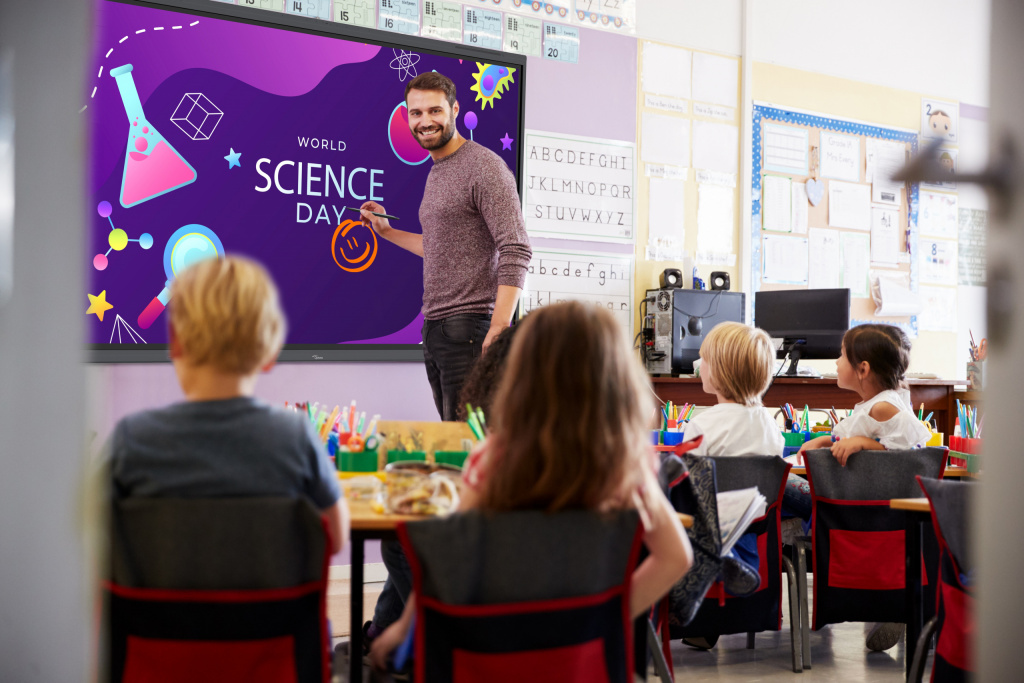 Primary school teacher using an interactive whiteboard to teach a science lesson.